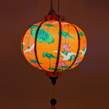 Round Vietnamese lantern with a gorgeous orange glow.