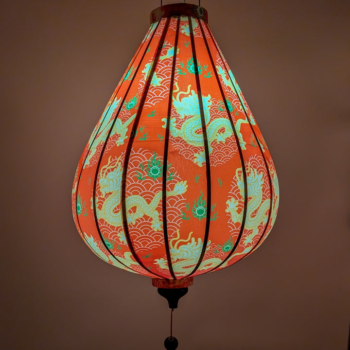 Glowing Vietnamese silk lantern with dragon design on bold red background.