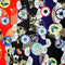 Polyester silk fabric with abstract print in red, black, blue and gold outline.