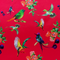 Polyester silk fabric used to create Vietnamese lanterns featuring a print of various birds in flight with bunches of peach flowers against a hot pink backdrop.