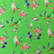 Polyester silk fabric with delicate peach flowers enhanced by various feathery avian species on an emerald green backdrop.