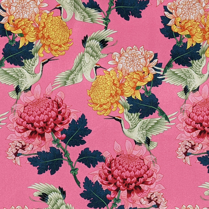 Pink polyester silk fabric with cranes and pink and yellow chrysanthemum flowers
