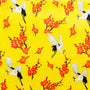 Polyester silk fabric with a print of cranes surrounded by orange flowers on a bright yellow background.
