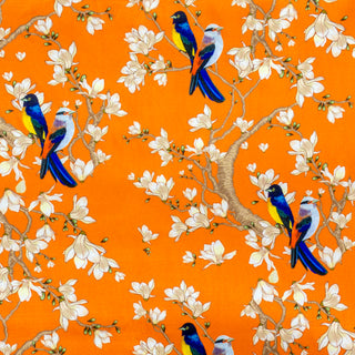 Orange polyester silk fabric with a print of bluebirds perched on branches amidst white flower blossoms.
