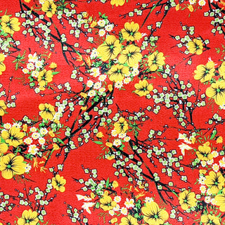 Red polyester silk fabric with a print of yellow flower blossoms with hints of green and white.