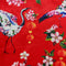 Polyester silk fabric with large Asian red-necked birds and round lanterns, surrounded by pink and white flowers on a red background.