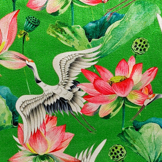 Polyester silk fabric with black-necked cranes and lotus flowers in bloom with large leaves on a vibrant green background.