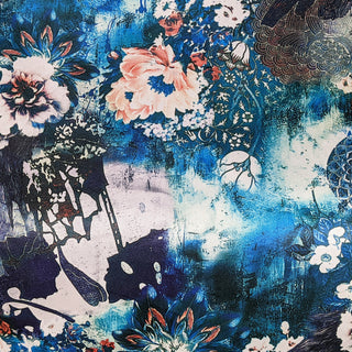 Polyester silk fabric with geometric shaped flowers in muted blue colours and hints of rose pink.