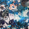 Polyester silk fabric with geometric shaped flowers in muted blue colours and hints of rose pink.