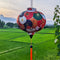 Round lantern with orange tassel set against a rice field taken at Chic Chillax Cafe in Hoi An, Quang Nam.