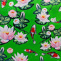 Green polyester silk fabric with red and white koi fish swimming around white and pink lotus flowers.