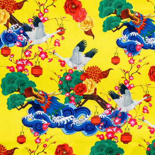 Fabric featuring cranes and dragons on bright yellow for handmade silk lanterns.