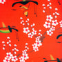 Polyester silk fabric used to create Hoi An Lanterns features intricate calligraphy and delicate pink cherry blossoms on red silk.