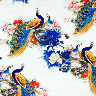 Polyester silk fabric with large, flamboyant peacocks surrounded by red, blue, and pink flowers on a white background. 