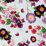 Polyester silk fabric with botanical floral pattern with pinks and purples on white background. 
