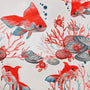 Polyester silk fabric with red goldfish and crabs amongst coral, shells, and seaweed on white.