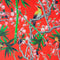 Polyester silk fabric with Blacknaped Oriole birds perched in a tree filled with pink flowers and surrounded by green bamboo plants on striking red.
