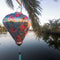 Balloon shaped lantern in the wild featuring pink and yellow roses on a light blue background.
