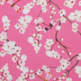 White flower blossoms and dragon flies on pink background.