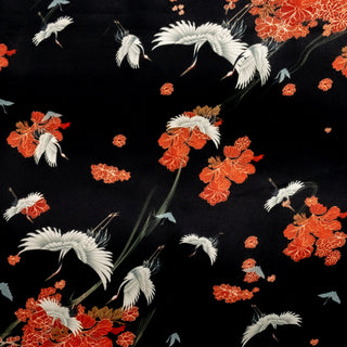 Black polyester silk fabric with white cranes swooping down and flying around falling orange flowers. This fabric is used to create our Hoi An Vietnamese Lanterns.